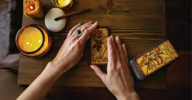 A person sitting at a table with a cell phone