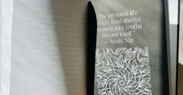 An open book displays a quote.