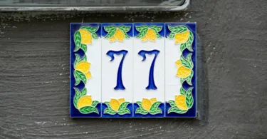 Number seventy-seven is displayed on a decorative tile.