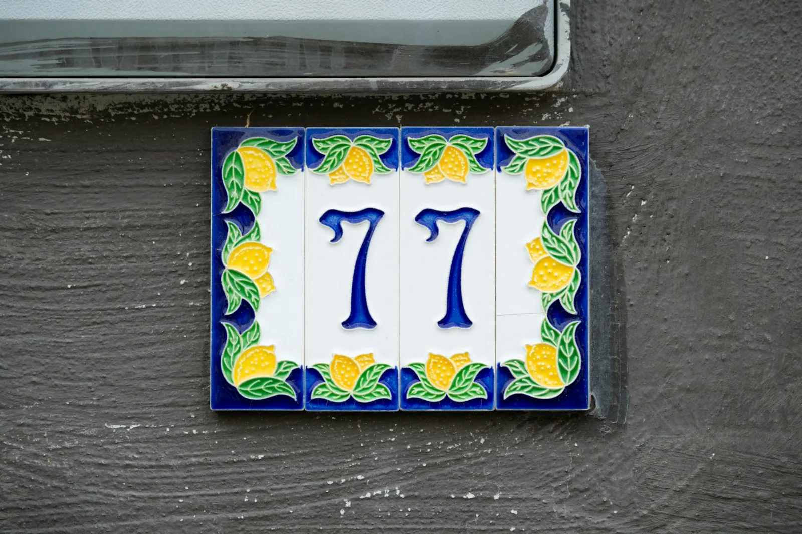 Number seventy-seven is displayed on a decorative tile.